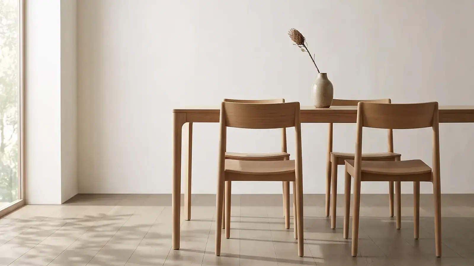 Greige oak plank floor in a bright dining area with a light wood table and chairs by a window