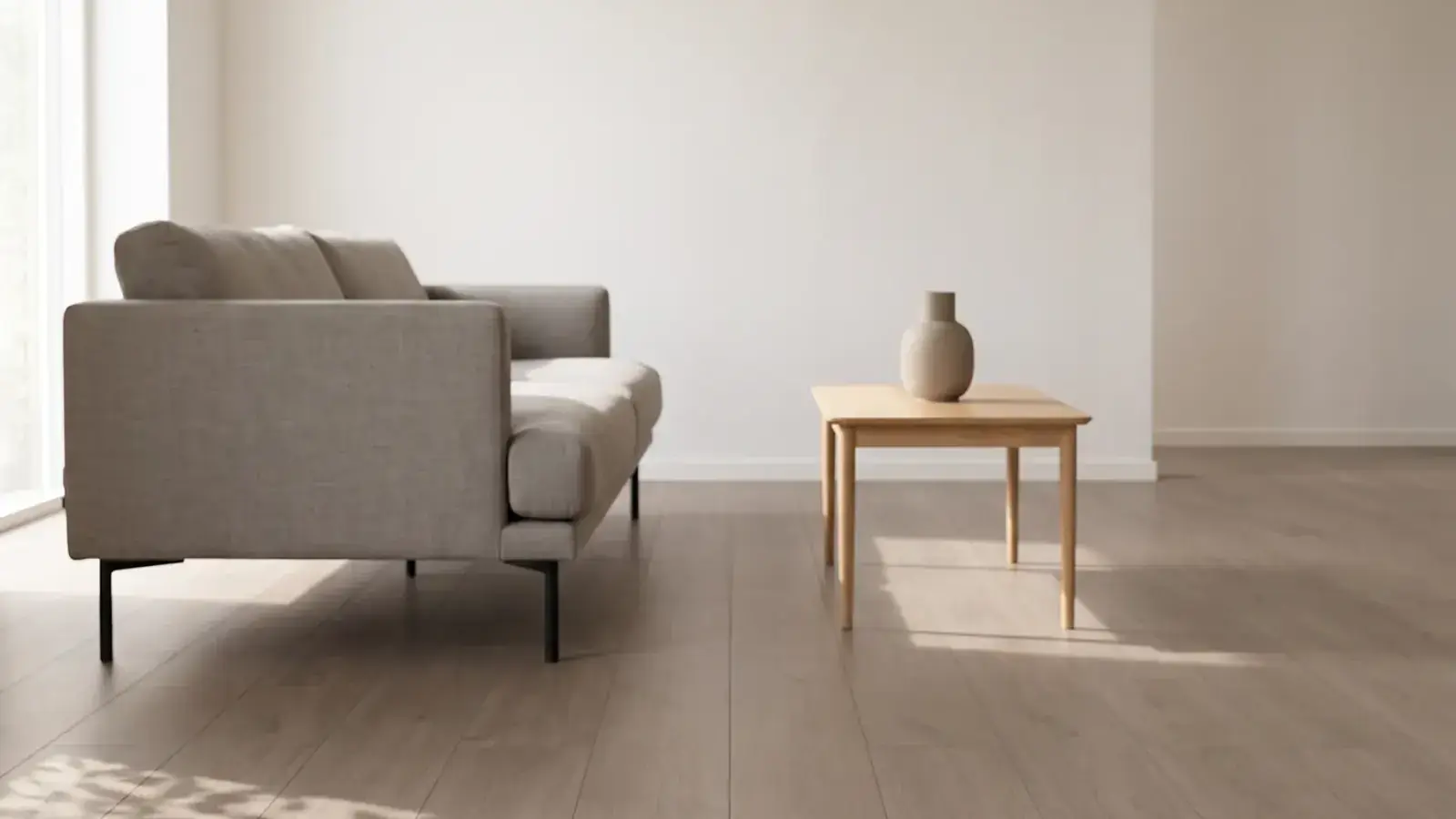 Greige oak plank floor in a bright, sparse living room with a linen sofa and a pale side table