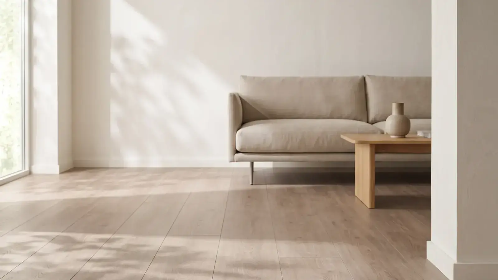 Light oak plank flooring in a bright living room with a linen sofa and a wooden coffee table by a window